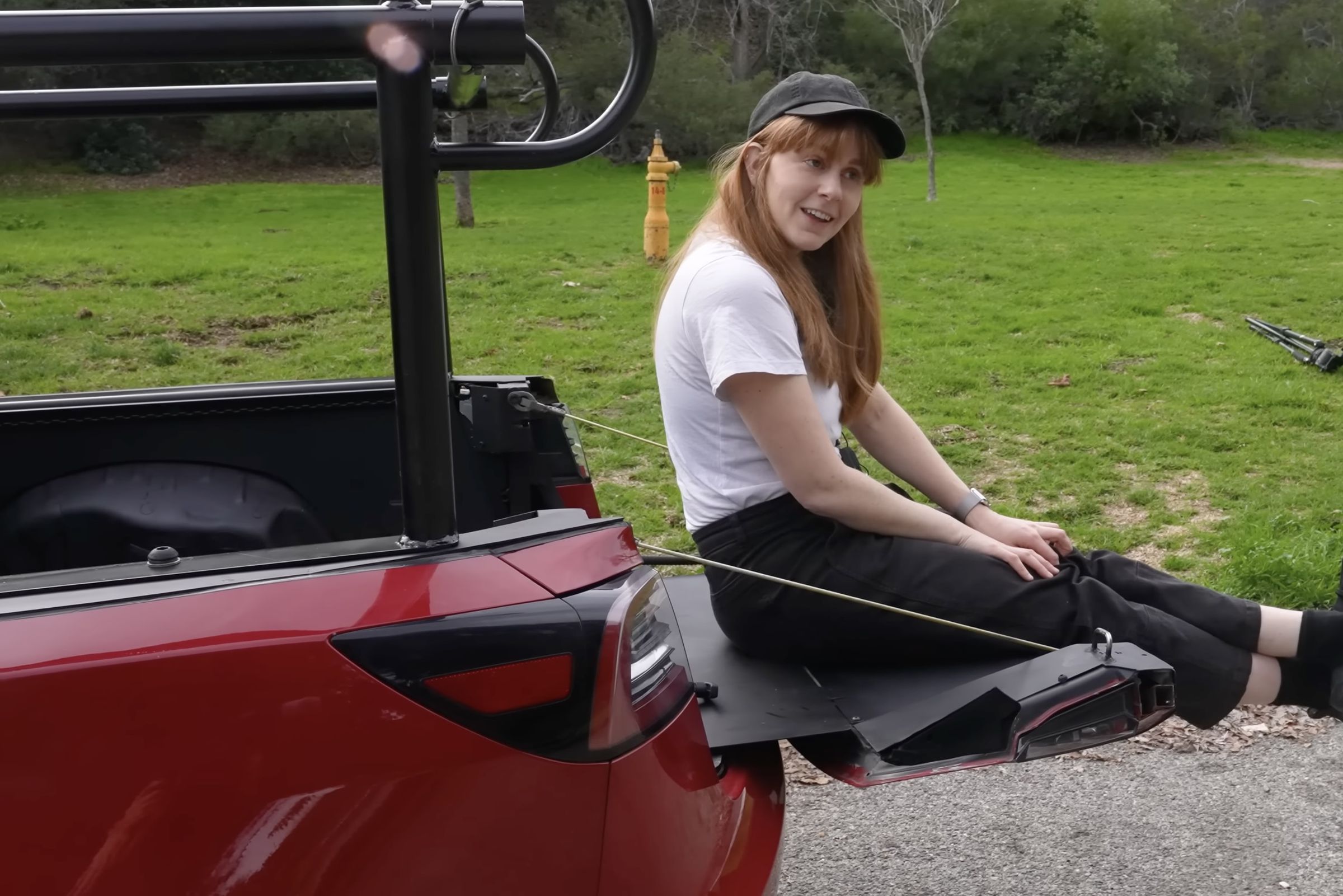 Simone Giertz sits on the end of the Truckla bed while it’s fully extended